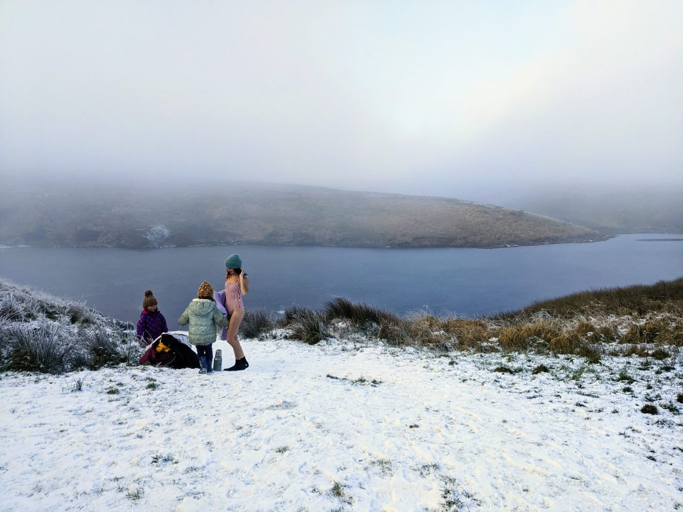 Swimming on a snow covered beach