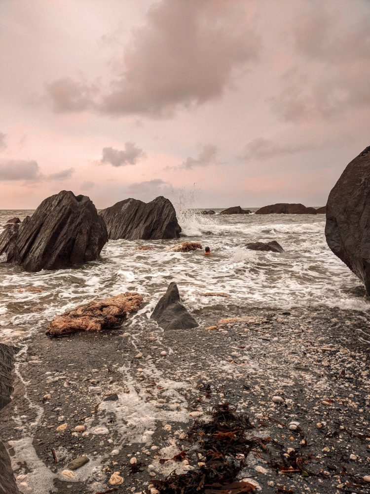 Cold water swimming on a rocky beach